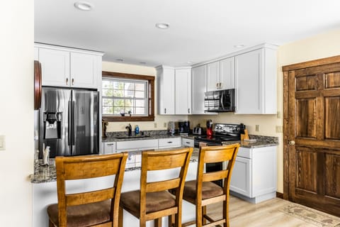 Kitchen counter with 3 seats.