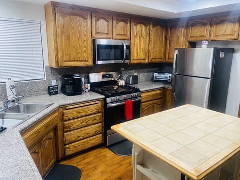 Large kitchen with 5-burner gas stove & microwave. Keurig dual coffee maker