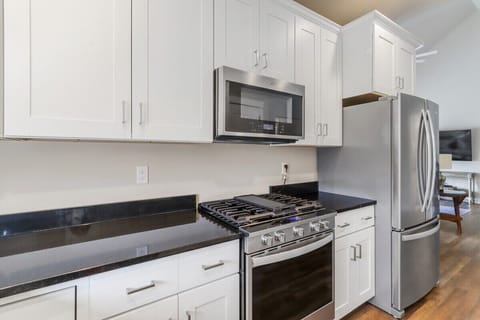 Beautiful fully equipped kitchen off living room.