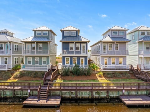 Charming waterfront homes with private docks line the peaceful canal, offering a perfect coastal retreat with direct water access.