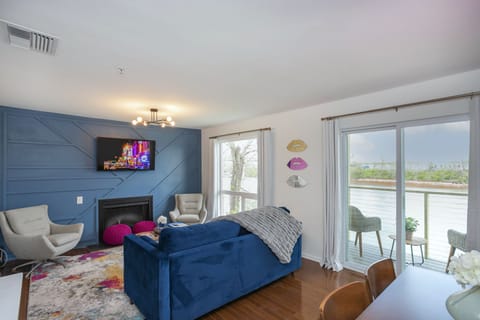 Fun & modern living area with SmartTV, fireplace and views of the river.