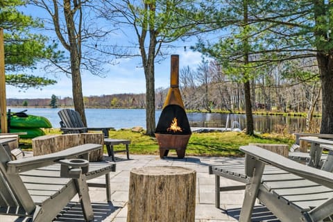 **Firepit** Cozy up with the family by the fire pit and soak in the stunning sunset views by the lake. Our Adirondack chairs and rustic tree stumps are the perfect seating for an unforgettable experience.
