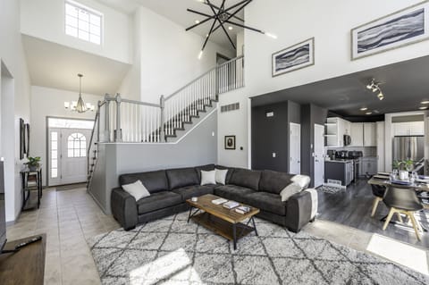 Living Room with gas fireplace, cathedral ceiling, & view of Green Mountain.