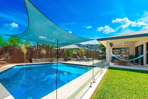 Surrounded by landscaped gardens and shade sails, the private pool offers a refreshing centrepiece for long tropical days spent outdoors.
