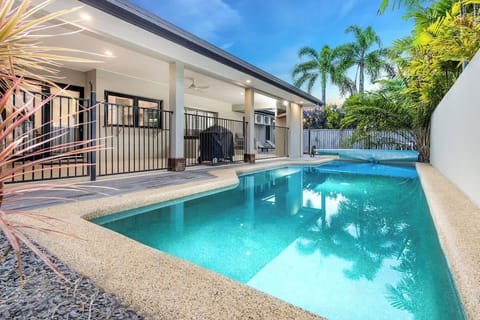 Spend warm tropical afternoons beside the sparkling private pool, where swaying palms and a covered patio create a relaxed outdoor retreat for lazy swims and easy entertaining.