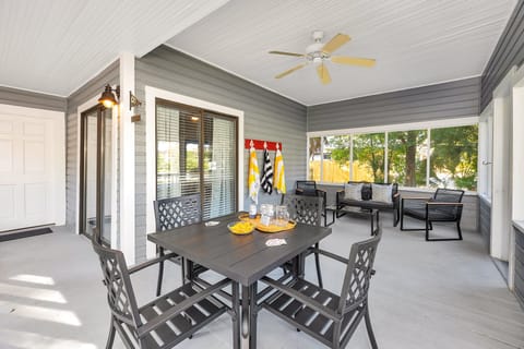Screened porch with dining table and seating