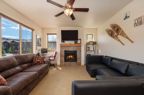 Relax in your spacious living room with crackling fireplace, mountain views, and cozy seating for memorable evenings together.