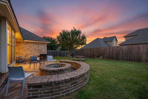 Spacious backyards for entertaining, wood firepit, and covered TV area with couch / chairs & dining table + picnic table in the backyard for dining. 