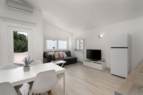 A comfy living room with a sofa bed for 1, a cable TV, air conditioning, and a dining area. #home #lovely #algarve #summer #airbnb