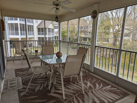 Large screened in back deck with outdoor dining