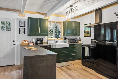 Full kitchen equipped with 3-stage under sink water filter system (no need for all those plastic bottles!!!), full sized fridge, electric range/oven, microwave, and coffee/tea station. We have stocked the kitchen with all your basic cooking and serving needs.