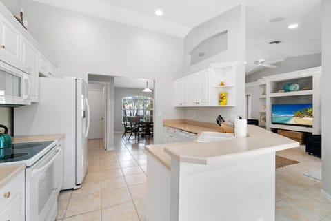 Set some snacks on the bar and keep the chef company while keeping an eye on the TV.