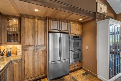 Full kitchen with stainless steel appliances and double oven.