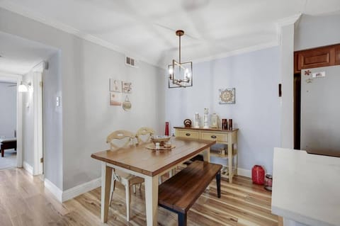 This cozy and inviting dining room features a beautiful wooden dining table perfect for gatherings with your favorite people.