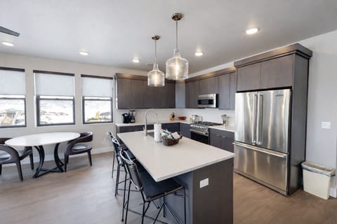 Experience bright, open-concept living in this modern space. Features include a gourmet kitchen with a large island, cozy dining area, and sun-drenched windows—perfect for a stylish group getaway.