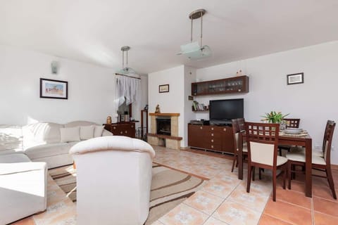 A bright living room with a comfortable sofa set, a wooden coffee table, and a patterned rug, creating a welcoming space.