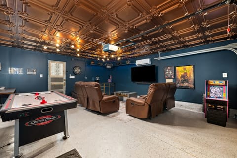 EPIC man cave complete with Foosball, air hockey, weights, PacMan, darts and a 65" smart tv and surround sound for maximum enjoyment!