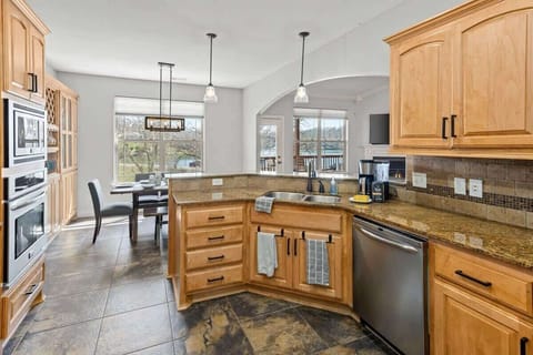 Prepare meals in the sunlight-drenched kitchen, with sweeping views of Lake Brittany, blending indoor comfort with outdoor tranquility.