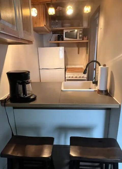 Kitchen with Bar Seating and Drip Coffee Maker