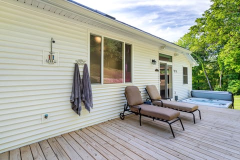 Outdoor shower, lounge chairs and hot tub on back deck. 