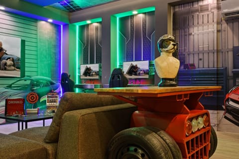 Race car gamer’s paradise with neon vibes, movie nights, and unique decor
