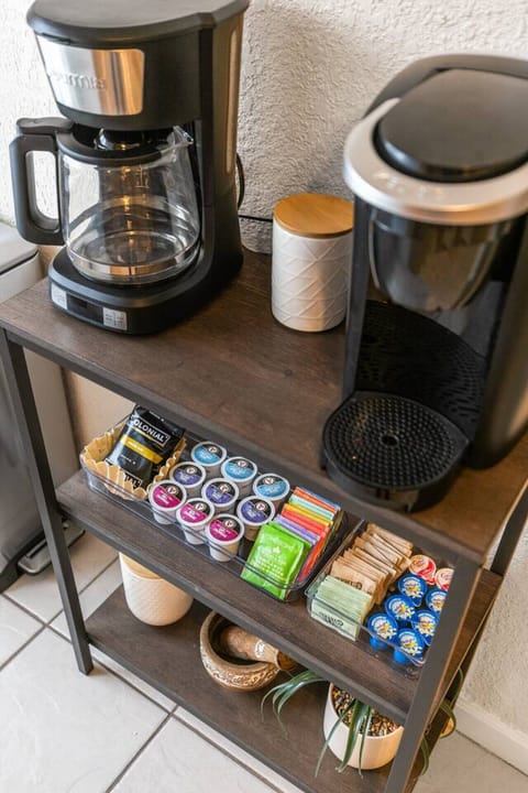 The coffee bar includes all the essentials for your morning brew including a 12-cup coffee maker and  a Keurig. We provide a starter pack of ground coffee, tea, K-cups, creamer, sugar and stevia. Enjoy!