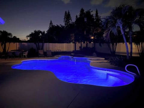 View of the lighted pool at night. Private backyard will allow you to use the pool at all times and feel like you are not surrounded by others. 