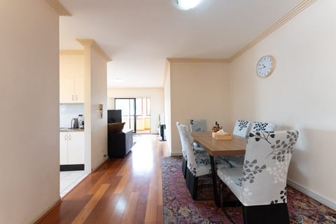 The dining area leading to the open plan living and balcony.