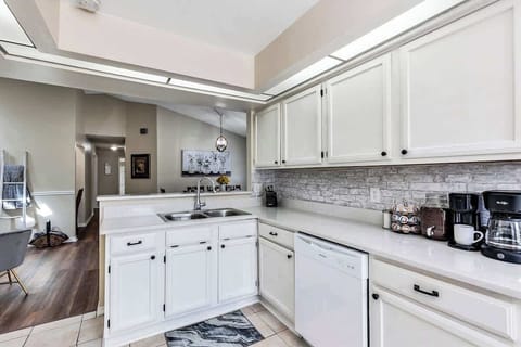 Clean and well functioning kitchen with breakfast nook w/2 chairs, oven, microwave, refrigerator, dishwasher, kettle, spice rack, k-cup & drip coffee maker, blender, toaster, silverware, cups, plates, bowls, coffee mugs, wine glasses, etc.