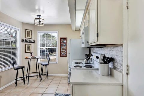 Clean and well functioning kitchen with breakfast nook w/2 chairs, oven, microwave, refrigerator, dishwasher, kettle, spice rack, k-cup & drip coffee maker, blender, toaster, silverware, cups, plates, bowls, coffee mugs, wine glasses, etc.