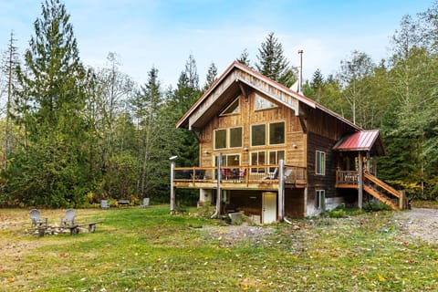 Exterior view of the house, looking at the raised deck and entryway on the right