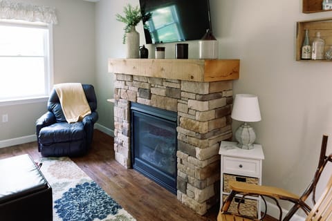 The Living Room features a gas fireplace, sofa bed, recliner and a rocking chair