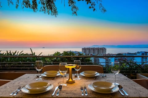[Terrace] Sunset dinner over Banderas Bay — the fireworks start around 9pm.
