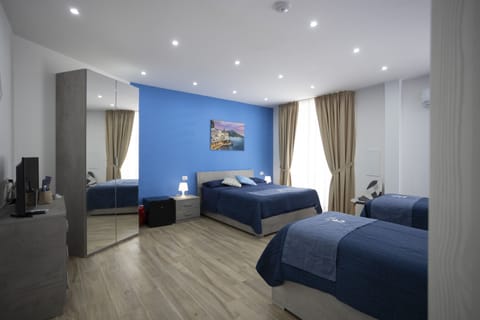 Deluxe Quadruple Room | Down comforters, desk, bed sheets