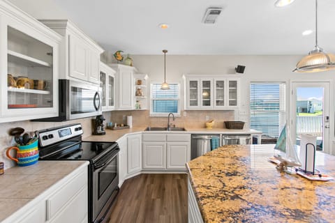 Get ready to whip up some delicious memories with this fully equipped kitchen!
