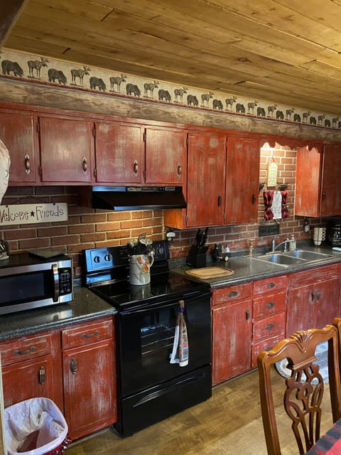 Fully stocked kitchen. Microwave and an electric stove.