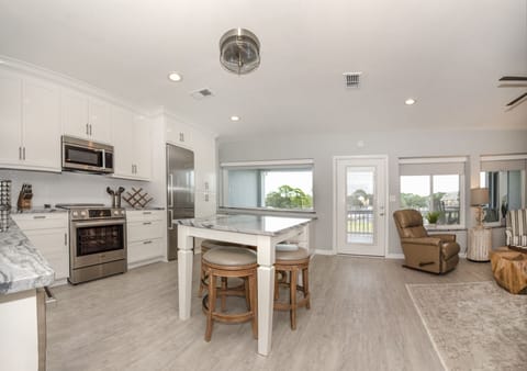 Living area, open to kitchen, marina view, 85-inch smart TV, double sleeper sofa