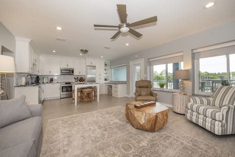 Living area, open to kitchen, marina view, 85-inch smart TV, double sleeper sofa
