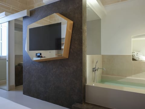 Deluxe Triple Room | Minibar, in-room safe, desk, blackout drapes