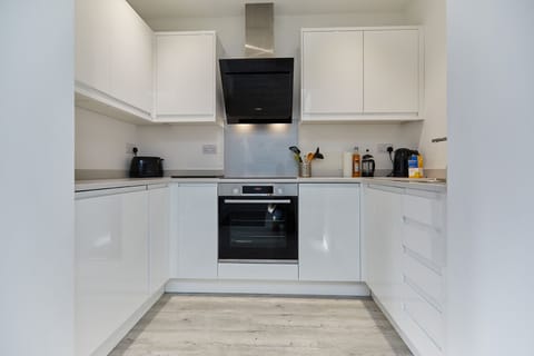 Kitchen with single oven, hob, microwave, dishwasher, fridge, Nespresso machine