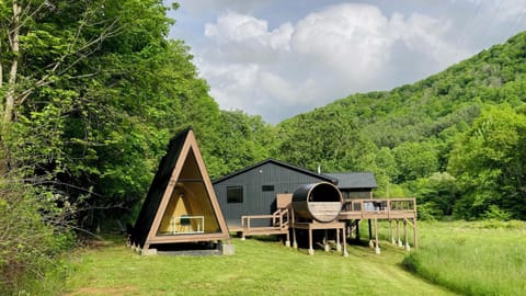 View of home, barrel sauna, A-frame, deck w/hot tub, shower, screened porch