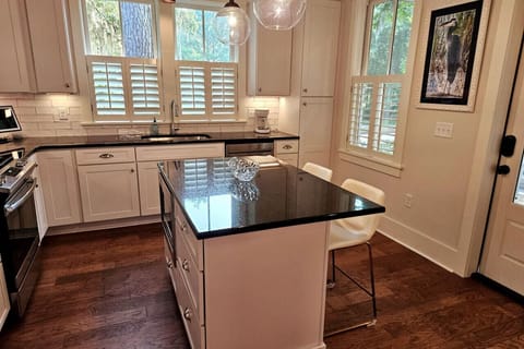 Kitchen rear door leads to screened porch and open deck