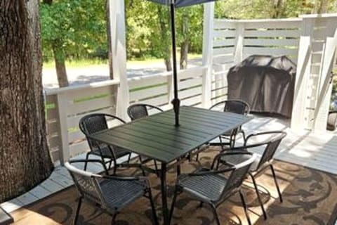 Table, chairs, umbrella and barbeque