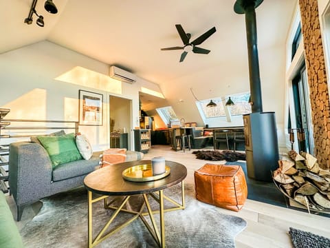 Sun soaked living room and kitchen surrounded by skylights