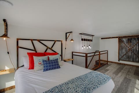 Hand made lamps, railing, closet door, desk are featured in the space