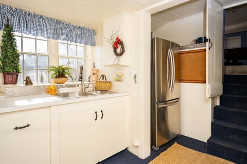 The laundry room is an expansion of the kitchen. With a Refrigator and microwave