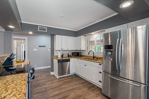 Our kitchen is a feast for the eyes and the taste buds, with sleek appliances, stylish finishes, and ample space to cook up a storm.