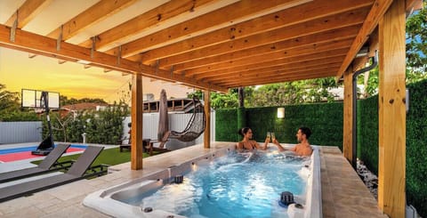 The Jacuzzi is surrounded by comfortable sun loungers