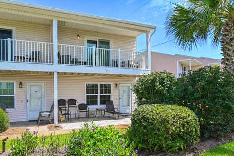 Welcome home! This charming two-story coastal cottage features a covered ground-floor patio with seating and a spacious upper balcony — perfect for soaking up the Florida sunshine and salty breeze right outside your door.