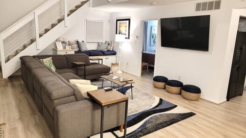 Family Room with massive 8+ person sectional, 2 reclining chairs on end.
65" Smart TV, Open concept for families..